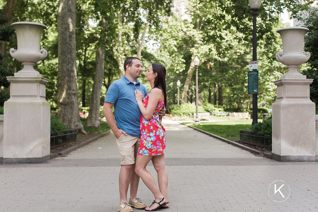 Engaged couple in front of Washington Square